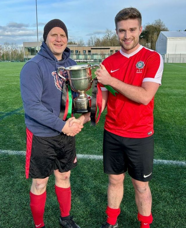 Steven Fleck receiving the McDowell Cup 2023 from League President Gary Busch